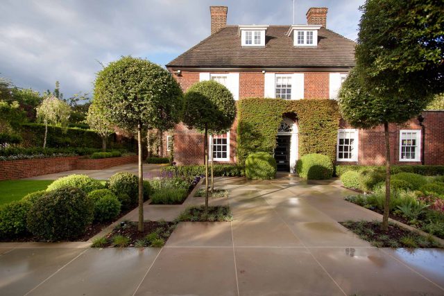 Stunning Suburban Garden constructed in Hampstead by Lynne Marcus also with Hunza exterior lighting illuminates asymmetrical landscape design, stone terrace.