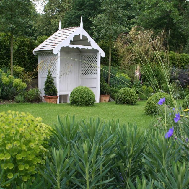 Gerrards Cross Garden Designer Romantic elegant terrace contemporary garden with manicured wide lawn in Northwood West London, striking bespoke cedar pergola.