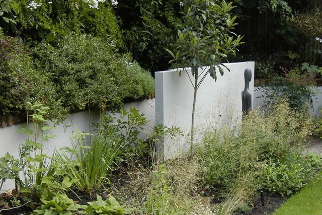 Family Garden Kent designed by Andy Sturgeon creates this Bickley garden constructed to provide a contemporary backdrop to the evergreen hedging planting.