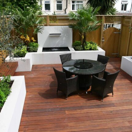 Decking design london elegant walled outdoor entertaining space Wimbledon South West London, lush planting, cozy relaxing outdoor dining area, water feature.