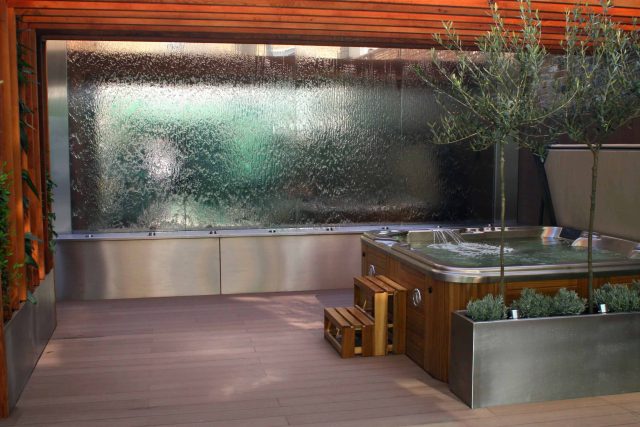 Outdoor hot tub and waterwall Garden Designs Plan Build in Central London Water feature constructed on-site along with the rear steel framework Highly Commended.