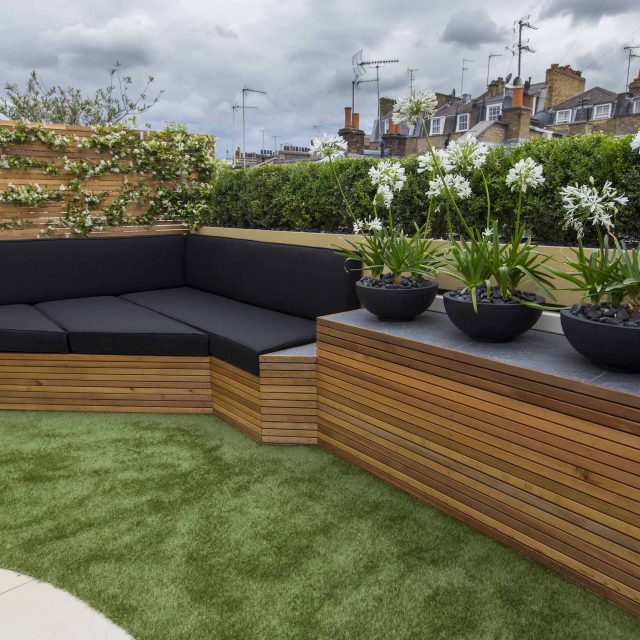 Vibrant funky roof terrace with Vistafolia artificial green wall by The Garden Builders, roof garden designers slate water feature providing another chic focal.
