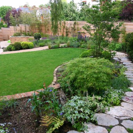 Family Garden in Hill Muswell providing space and tranquillity, modern slatted trellis, hard landscaping, slate terrace
