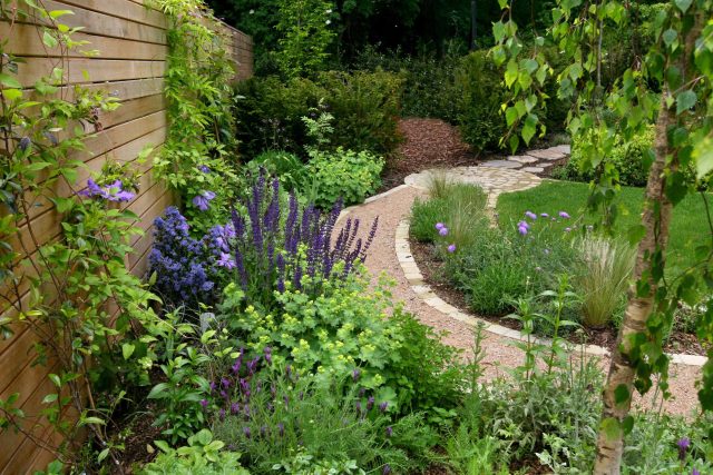 Family Garden in Hill Muswell providing space and tranquillity, modern slatted trellis, hard landscaping, slate terrace