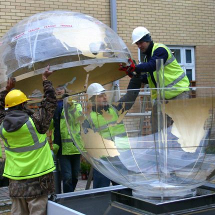 Garden Design Sphere Water Feature set in the courtyard of a London Hospital dynamic steel water feature a clear acrylic sphere included map of the world.