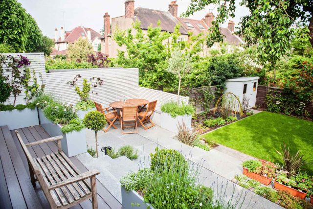 Landscaped multi-levelled contemporary garden designed with basalt paving, bespoke steel planters in Muswell Hill London landscaping contractor designers.