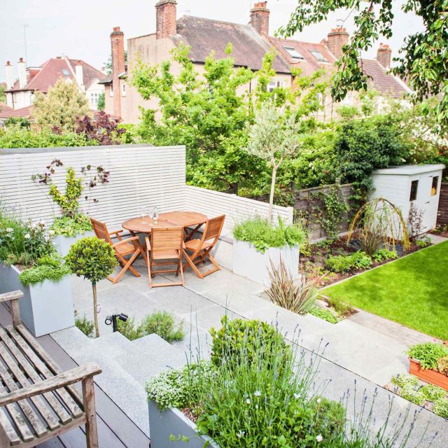 Landscaped multi-levelled contemporary garden designed with basalt paving, bespoke steel planters in Muswell Hill London landscaping contractor designers.