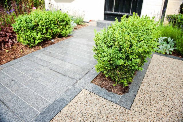 Landscaped multi-levelled contemporary garden designed with basalt paving, bespoke steel planters in Muswell Hill London landscaping contractor designers.