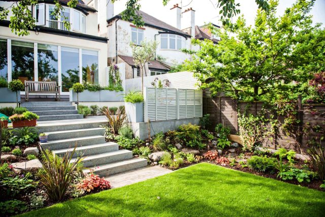 Landscaped multi-levelled contemporary garden designed with basalt paving, bespoke steel planters in Muswell Hill London landscaping contractor designers.