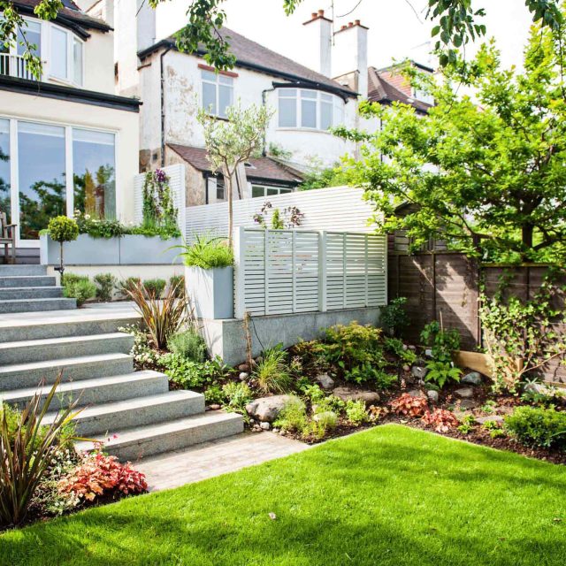 Landscaped multi-levelled contemporary garden designed with basalt paving, bespoke steel planters in Muswell Hill London landscaping contractor designers.