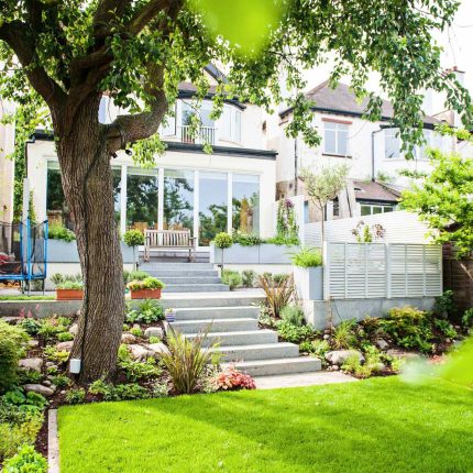 Landscaped multi-levelled contemporary garden designed with basalt paving, bespoke steel planters in Muswell Hill London landscaping contractor designers.