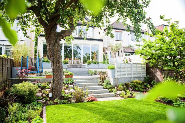 Landscaped multi-levelled contemporary garden designed with basalt paving, bespoke steel planters in Muswell Hill London landscaping contractor designers.