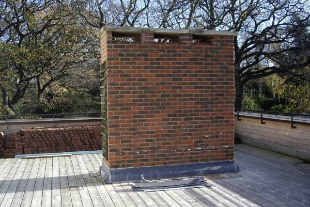 Roof Terrace design in Highgate a bespoke contemporary space with sleek bespoke slate water features steel planters planting olive tree horticulturalist.