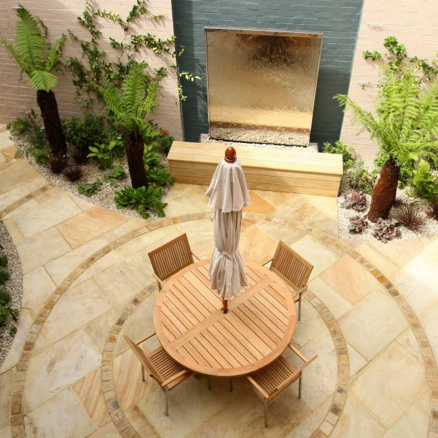Courtyard garden for NHS GP Practice Balham Surgery south London with water feature and lighting, landscaping consultant contractors lighting, planting.