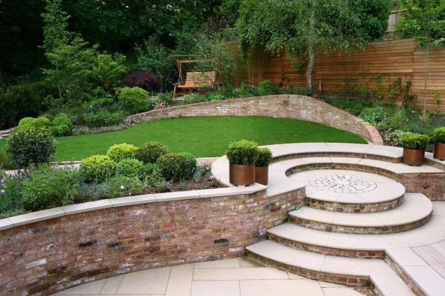 Family Garden in Hill Muswell providing space and tranquillity, modern slatted trellis, hard landscaping, slate terrace