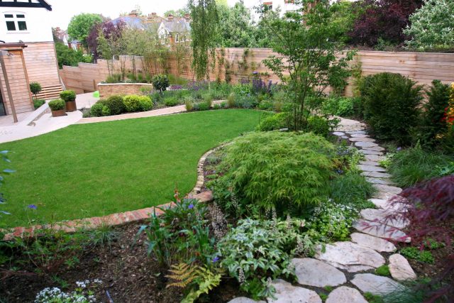 Family Garden in Hill Muswell providing space and tranquillity, modern slatted trellis, hard landscaping, slate terrace