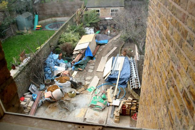 Modern Family Garden in Battersea with patio lighting planting and machined sandstone pathway specialist company stone work, planting herbaceous perennials.