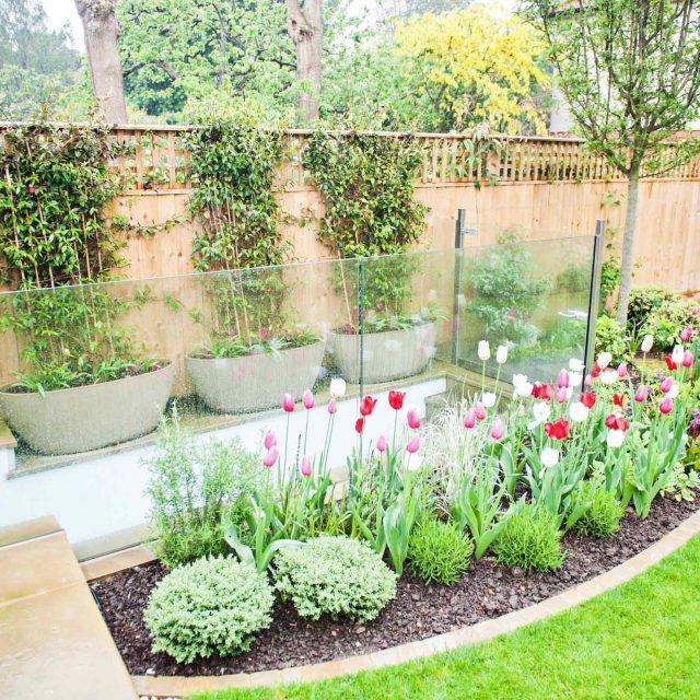 Wandsworth Urban Garden with York Stone paving, basement and entrance steps, complicated glass and steel works designs, hard soft landscaping, garden terrace.