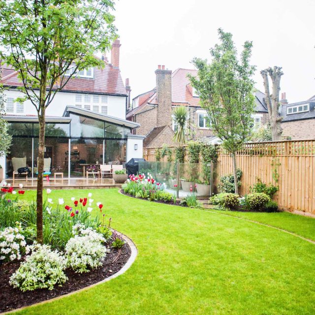 Wandsworth Urban Garden with York Stone paving, basement and entrance steps, complicated glass and steel works designs, hard soft landscaping, garden terrace.