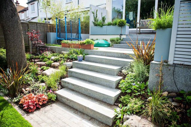 Landscaped multi-levelled contemporary garden designed with basalt paving, bespoke steel planters in Muswell Hill London landscaping contractor designers.