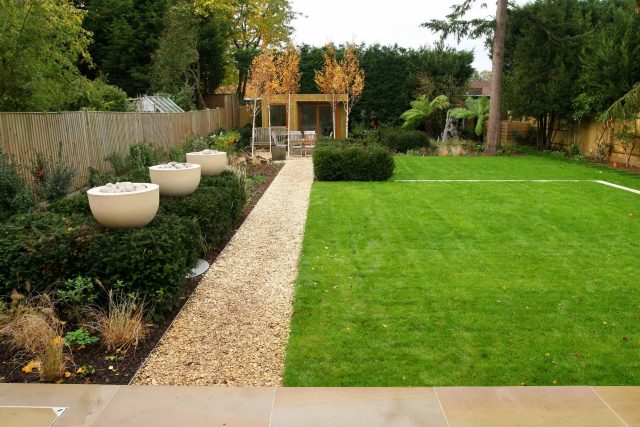Epsom, Surrey landscaped garden lawn, minimalist design with pebble border and Birch trees, Ewell, Surrey contractor specialists, lawns, pathways, driveways.