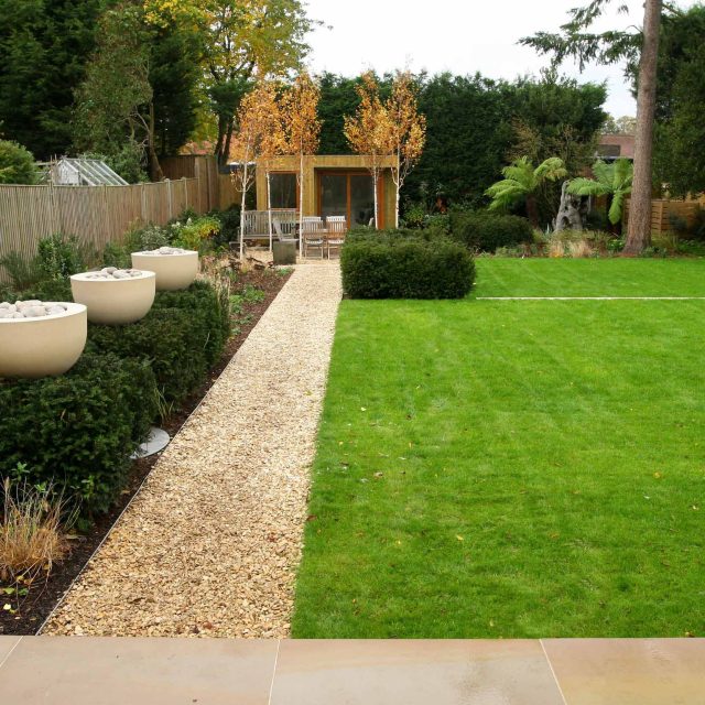 Epsom, Surrey landscaped garden lawn, minimalist design with pebble border and Birch trees, Ewell, Surrey contractor specialists, lawns, pathways, driveways.