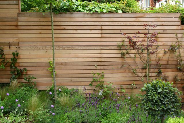 Family Garden in Hill Muswell providing space and tranquillity, modern slatted trellis, hard landscaping, slate terrace