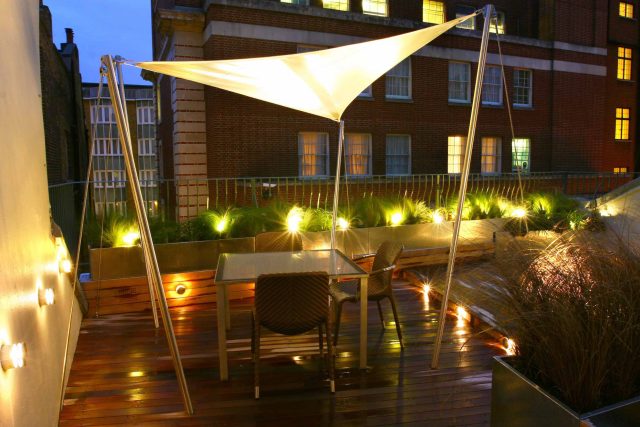 City Roof Terrace Marylebone W1 designed by Joan Edlis of Joan Edlis Associates and built by the Garden Builders decked floor surface, stainless steel planters.