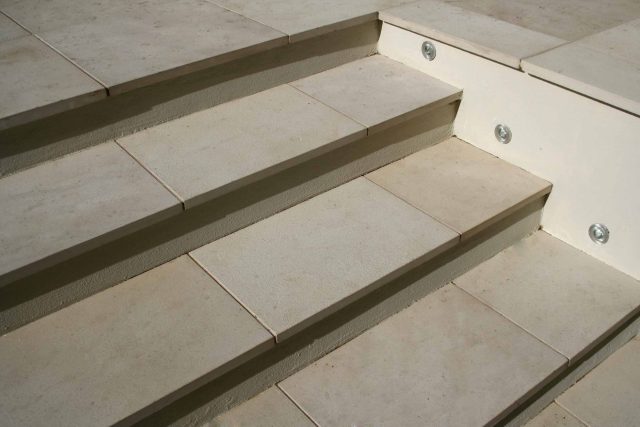 Modern Family Garden in Battersea with patio lighting planting and machined sandstone pathway specialist company stone work, planting herbaceous perennials.