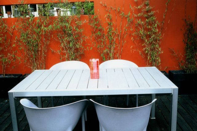 Child friendly synthetic lawn designed as a low-maintenance, contemporary and colourful space, planted raised beds slate terrace hardwood tree seat specialists.