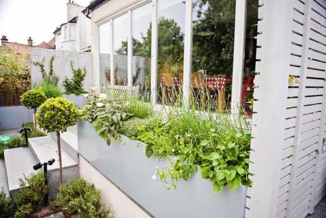 Landscaped multi-levelled contemporary garden designed with basalt paving, bespoke steel planters in Muswell Hill London landscaping contractor designers.