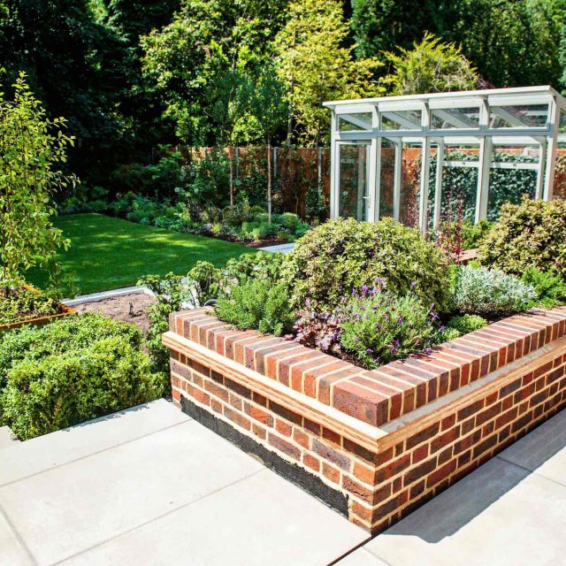 Large garden using Portland stone and steel planters in Hampstead by designer Lynne Marcus, excavation construction hard landscaping specialist in London.