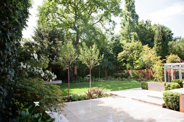 Large garden using Portland stone and steel planters in Hampstead by designer Lynne Marcus, excavation construction hard landscaping specialist in London.