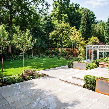 Large garden using Portland stone and steel planters in Hampstead by designer Lynne Marcus, excavation construction hard landscaping specialist in London.