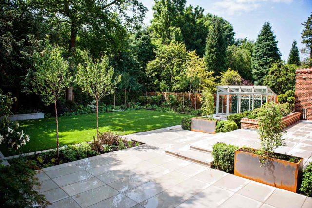 Large garden using Portland stone and steel planters in Hampstead by designer Lynne Marcus, excavation construction hard landscaping specialist in London.