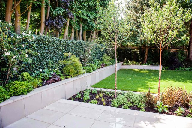 Large garden using Portland stone and steel planters in Hampstead by designer Lynne Marcus, excavation construction hard landscaping specialist in London.