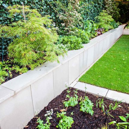 Large garden using Portland stone and steel planters in Hampstead by designer Lynne Marcus, excavation construction hard landscaping specialist in London.