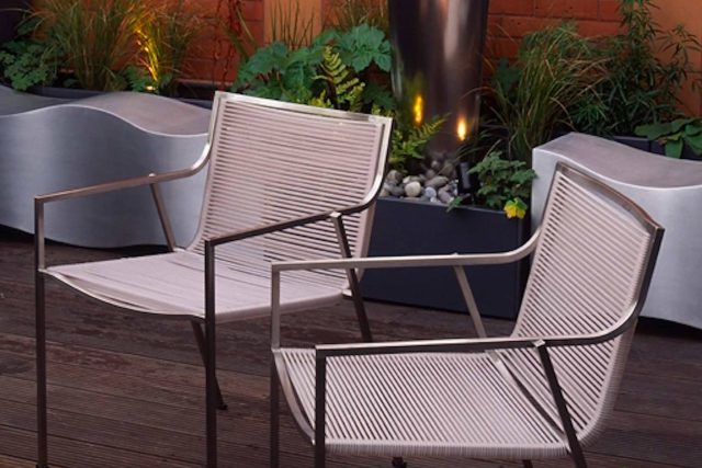 Garden roof terrace Knightsbridge designed with limestone circular table, integrated flambeaux gas unit by Andy Sturgeon, specialist builders, landscapers.