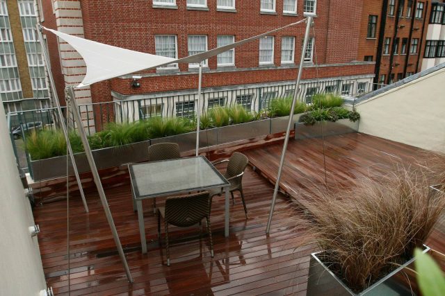 City Roof Terrace Marylebone W1 designed by Joan Edlis of Joan Edlis Associates and built by the Garden Builders decked floor surface, stainless steel planters.