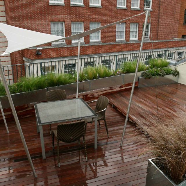 City Roof Terrace Marylebone W1 designed by Joan Edlis of Joan Edlis Associates and built by the Garden Builders decked floor surface, stainless steel planters.