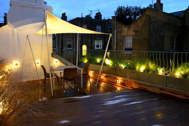 City Roof Terrace Marylebone W1 designed by Joan Edlis of Joan Edlis Associates and built by the Garden Builders decked floor surface, stainless steel planters.
