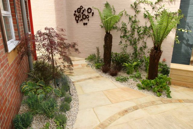 Courtyard garden for NHS GP Practice Balham Surgery south London with water feature and lighting, landscaping consultant contractors lighting, planting.