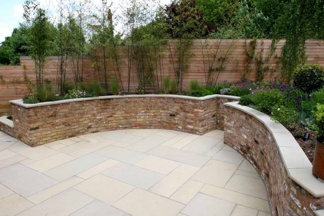 Family Garden in Hill Muswell providing space and tranquillity, modern slatted trellis, hard landscaping, slate terrace