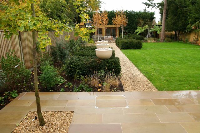 Epsom, Surrey landscaped garden lawn, minimalist design with pebble border and Birch trees, Ewell, Surrey contractor specialists, lawns, pathways, driveways.