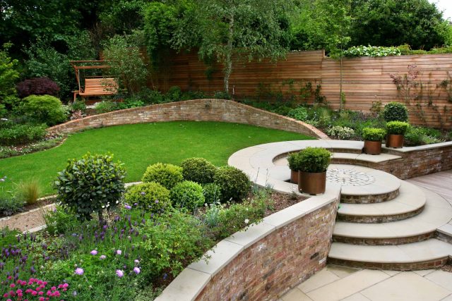 Family Garden in Hill Muswell providing space and tranquillity, modern slatted trellis, hard landscaping, slate terrace