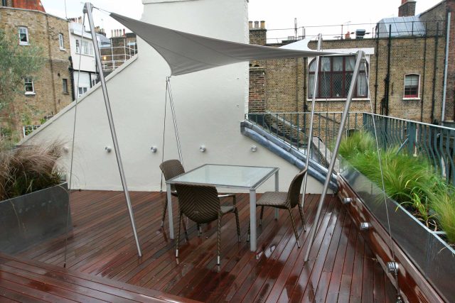 City Roof Terrace Marylebone W1 designed by Joan Edlis of Joan Edlis Associates and built by the Garden Builders decked floor surface, stainless steel planters.