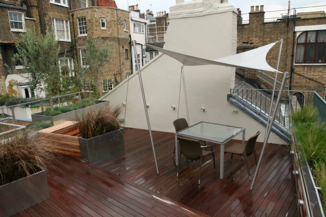 City Roof Terrace Marylebone W1 designed by Joan Edlis of Joan Edlis Associates and built by the Garden Builders decked floor surface, stainless steel planters.