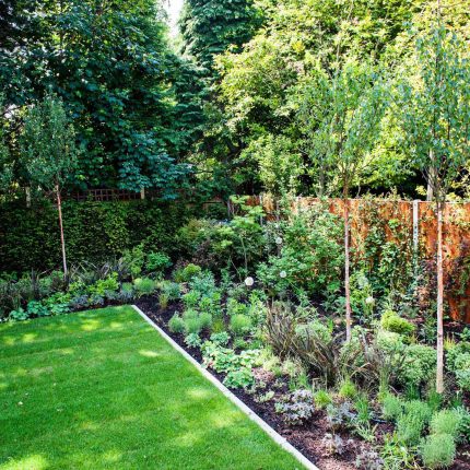 Large garden using Portland stone and steel planters in Hampstead by designer Lynne Marcus, excavation construction hard landscaping specialist in London.