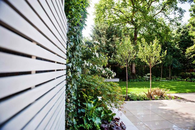 Large garden using Portland stone and steel planters in Hampstead by designer Lynne Marcus, excavation construction hard landscaping specialist in London.