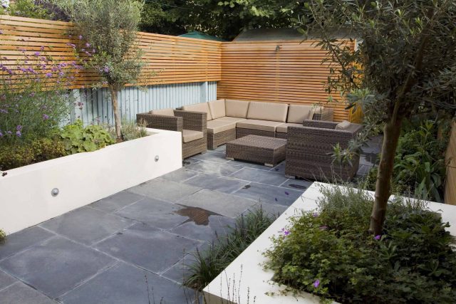 Small Contemporary designed garden consultants Putney with rendered raised beds, slate and basalt paving, timber screening in horizontal slatted design London.
